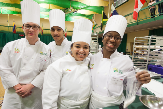 diverse group of smiling culinary students. 