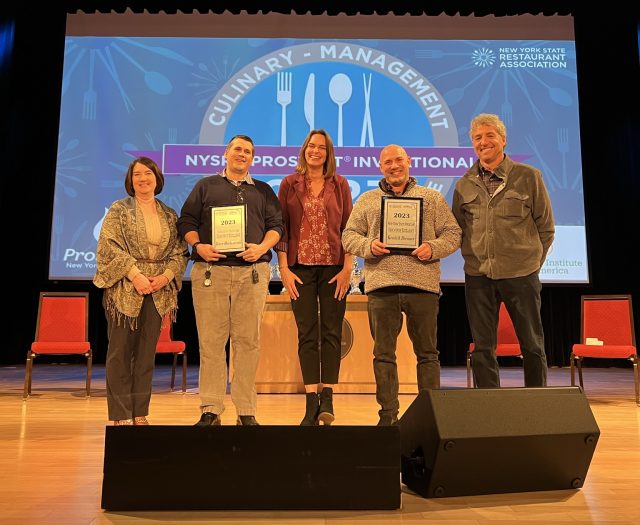 Winners of Educator of the Year award accepting trophies